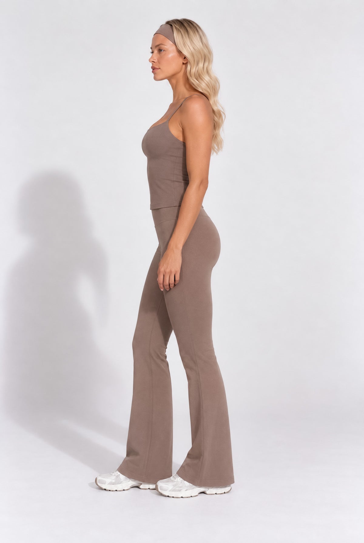 Truffle brown organic cotton flare leggings worn with a matching cami top.