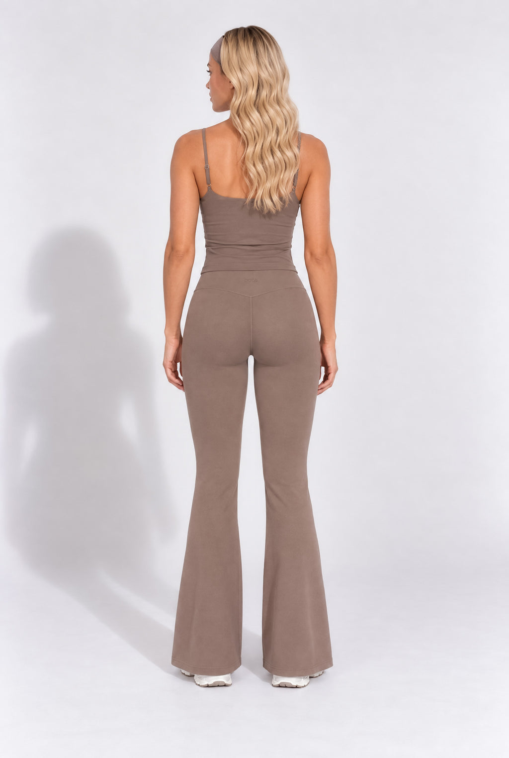 Back view of truffle brown organic cotton flare leggings with a matching cami top.