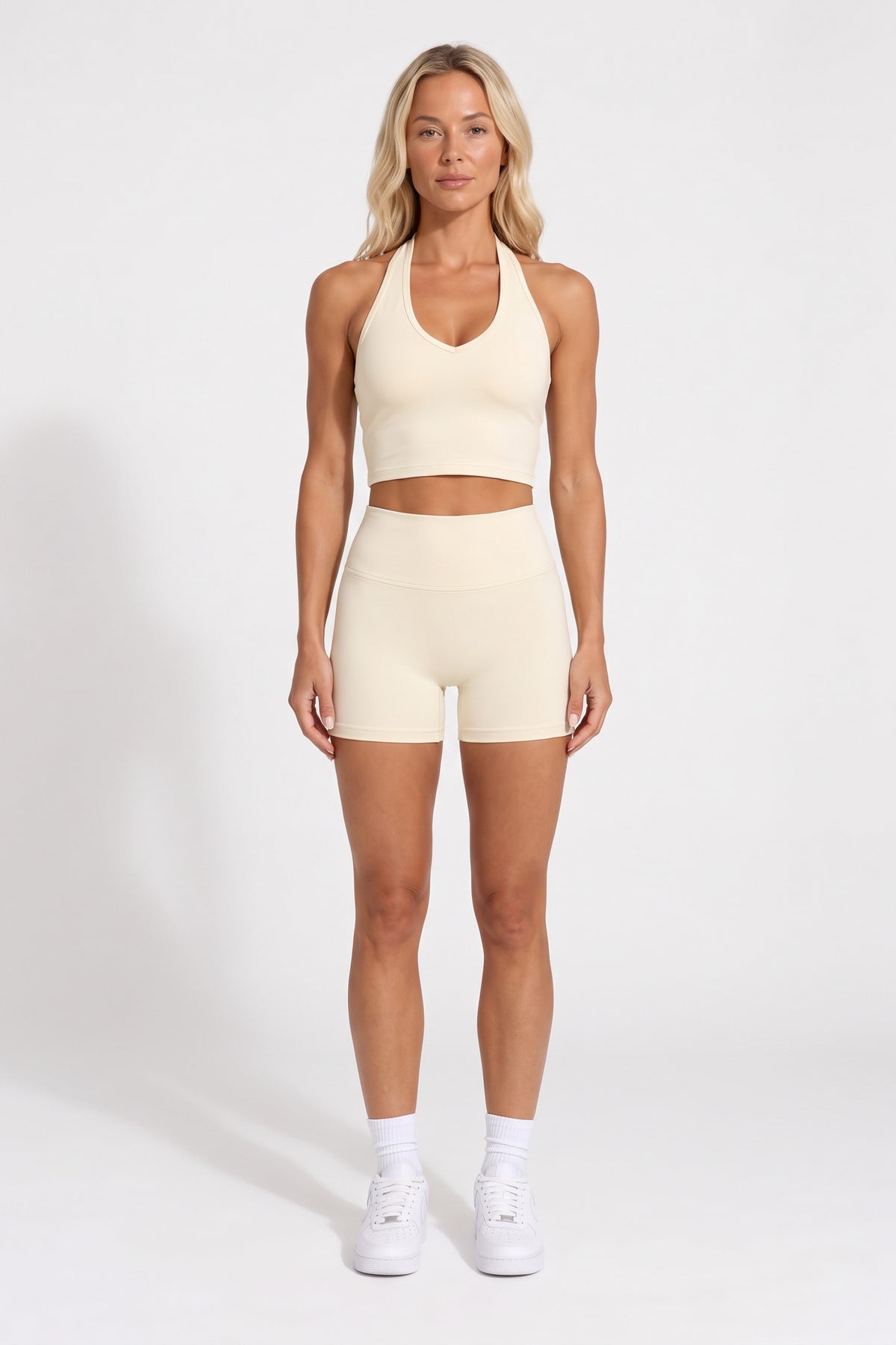Buttercream organic cotton high-waisted shorts and halter top, full-length view.