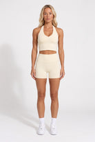 Buttercream organic cotton high-waisted shorts and halter top, full-length view.