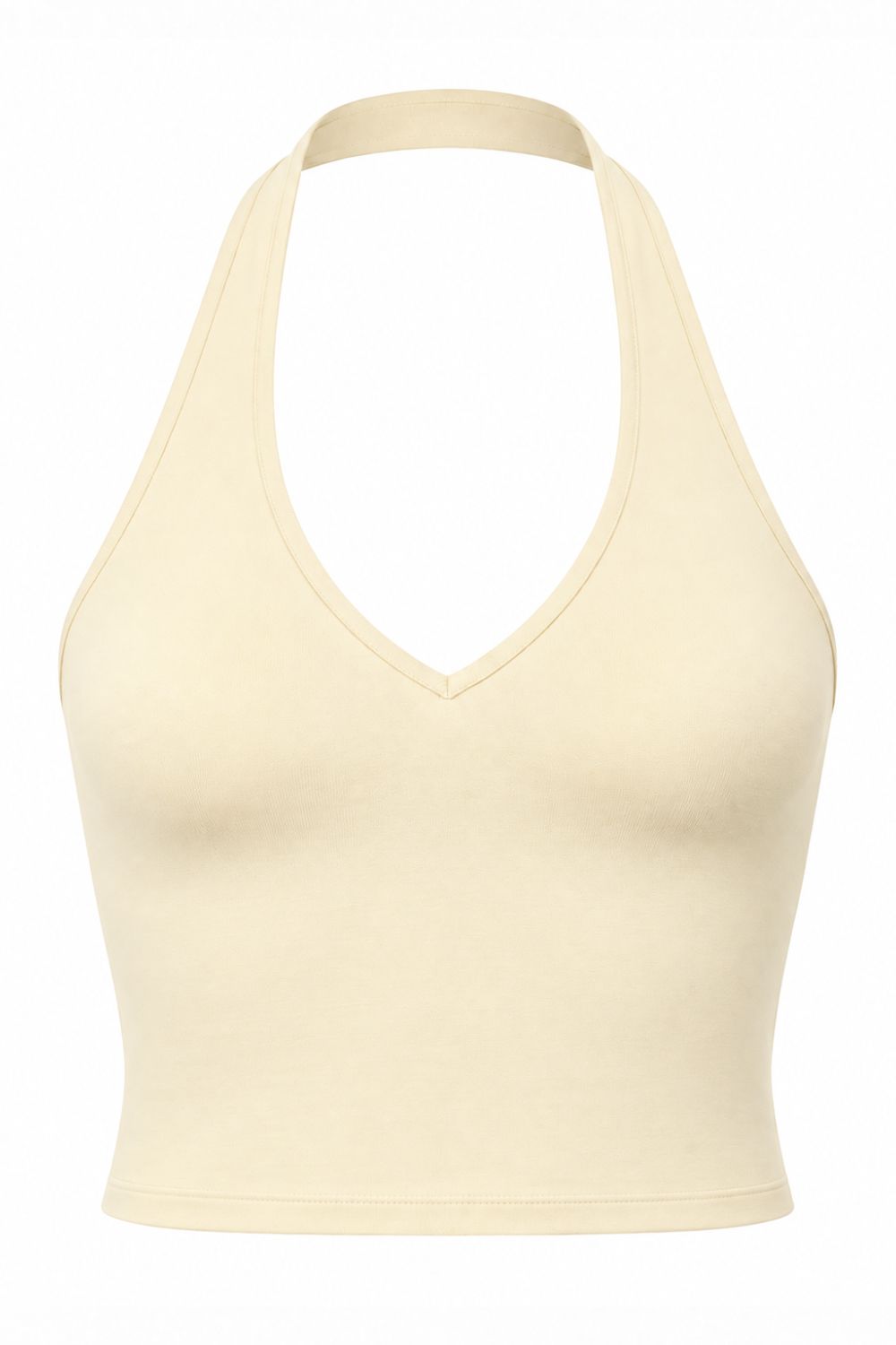 Woman wearing a buttercream organic cotton halter top, cropped and fitted.