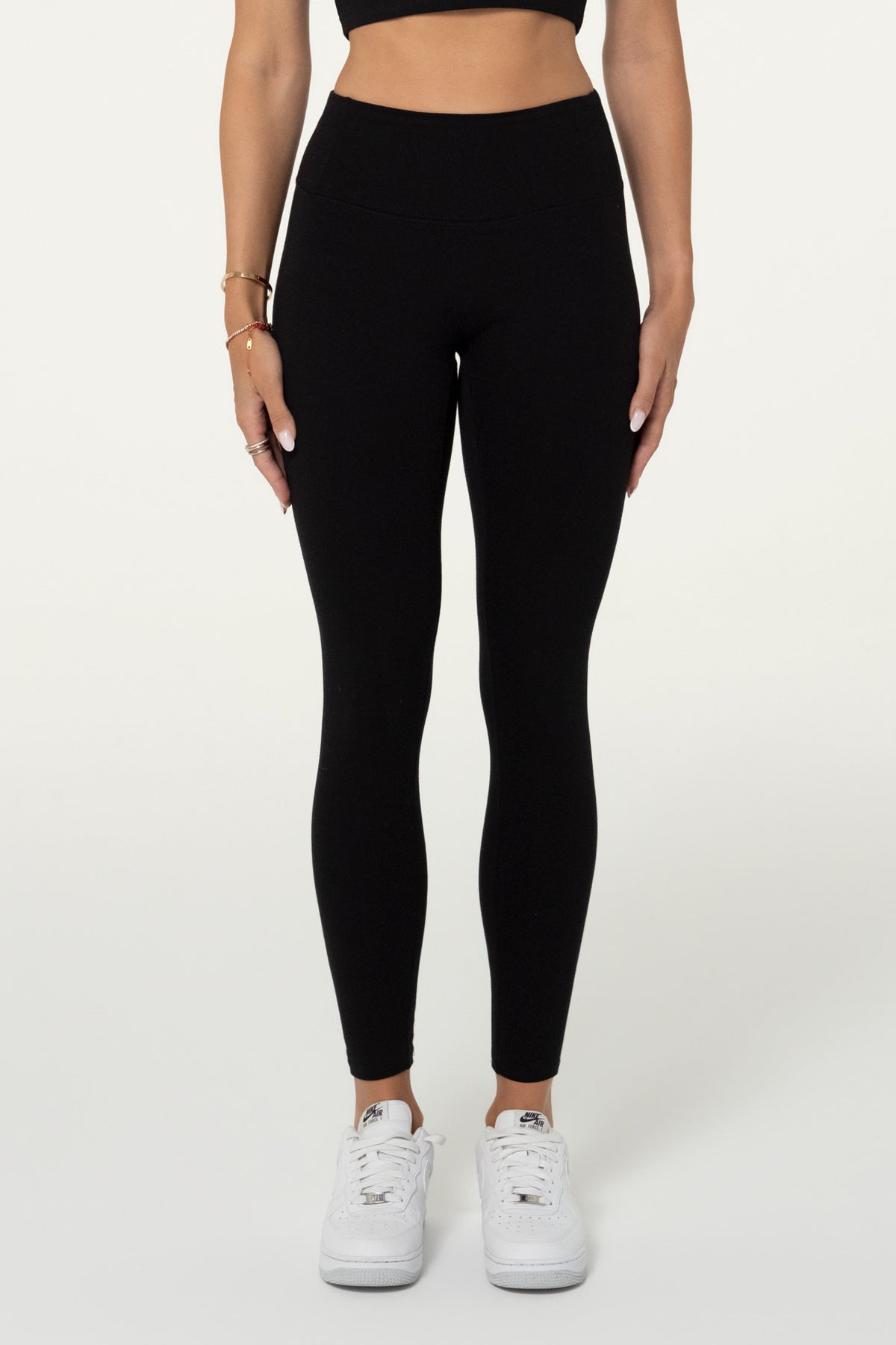 Black organic cotton high-waisted 7/8 leggings, full-length front view.