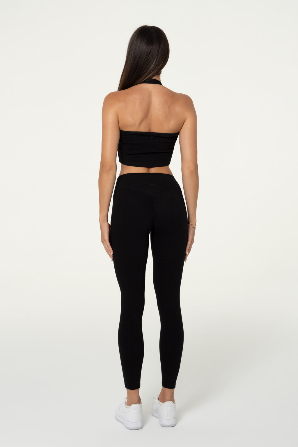 Back view of black organic cotton leggings showing the invisible shaping detail.