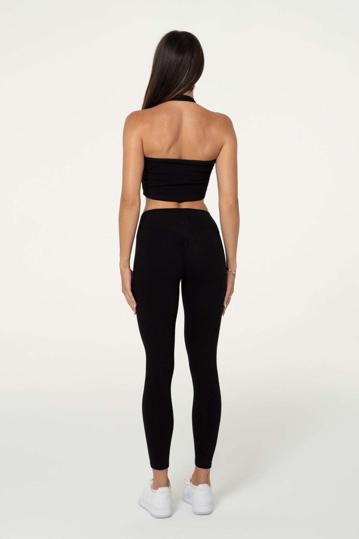 Back view of black organic cotton leggings showing the invisible shaping detail.