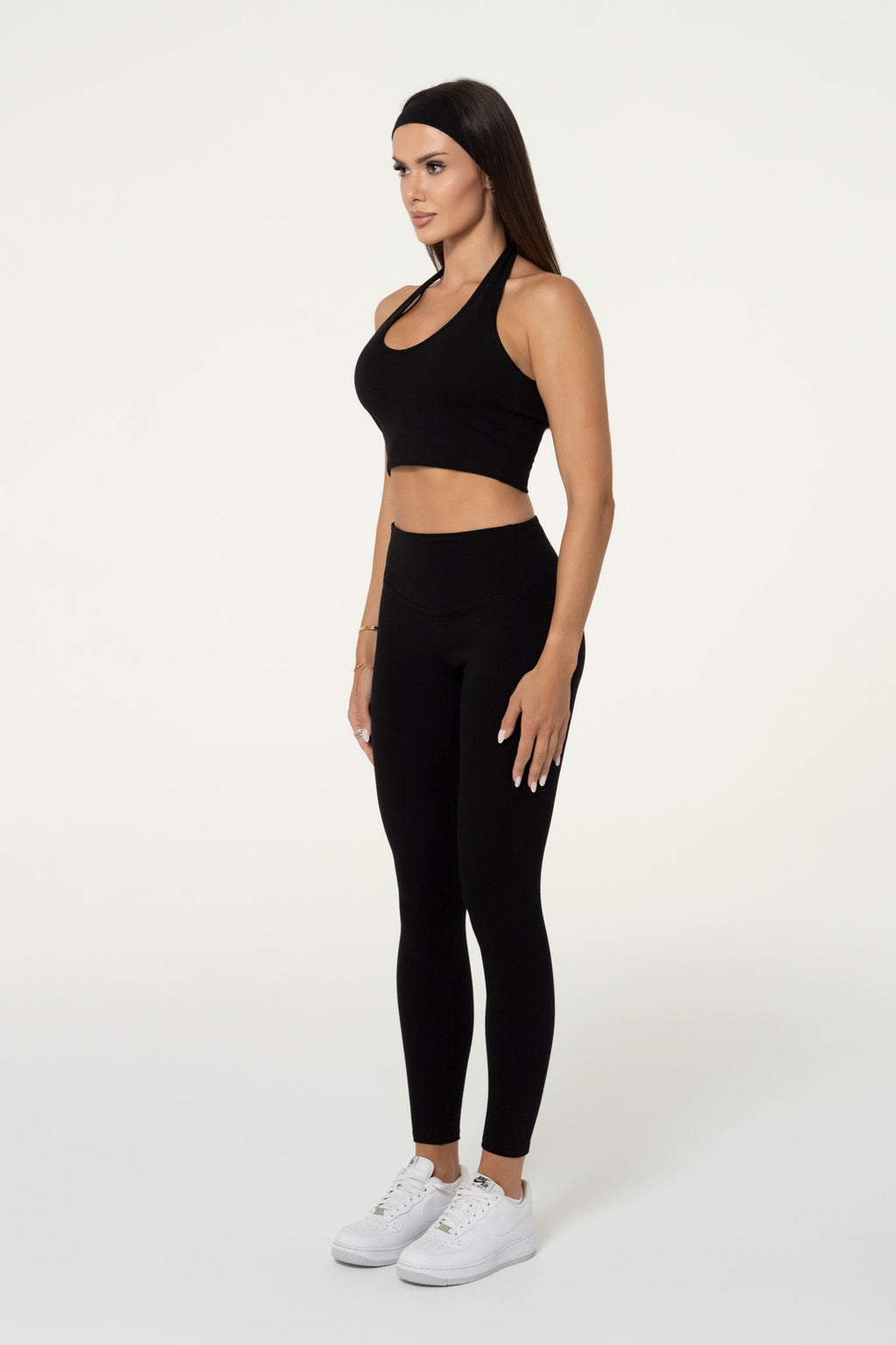 Side view of black organic cotton high-waisted leggings.