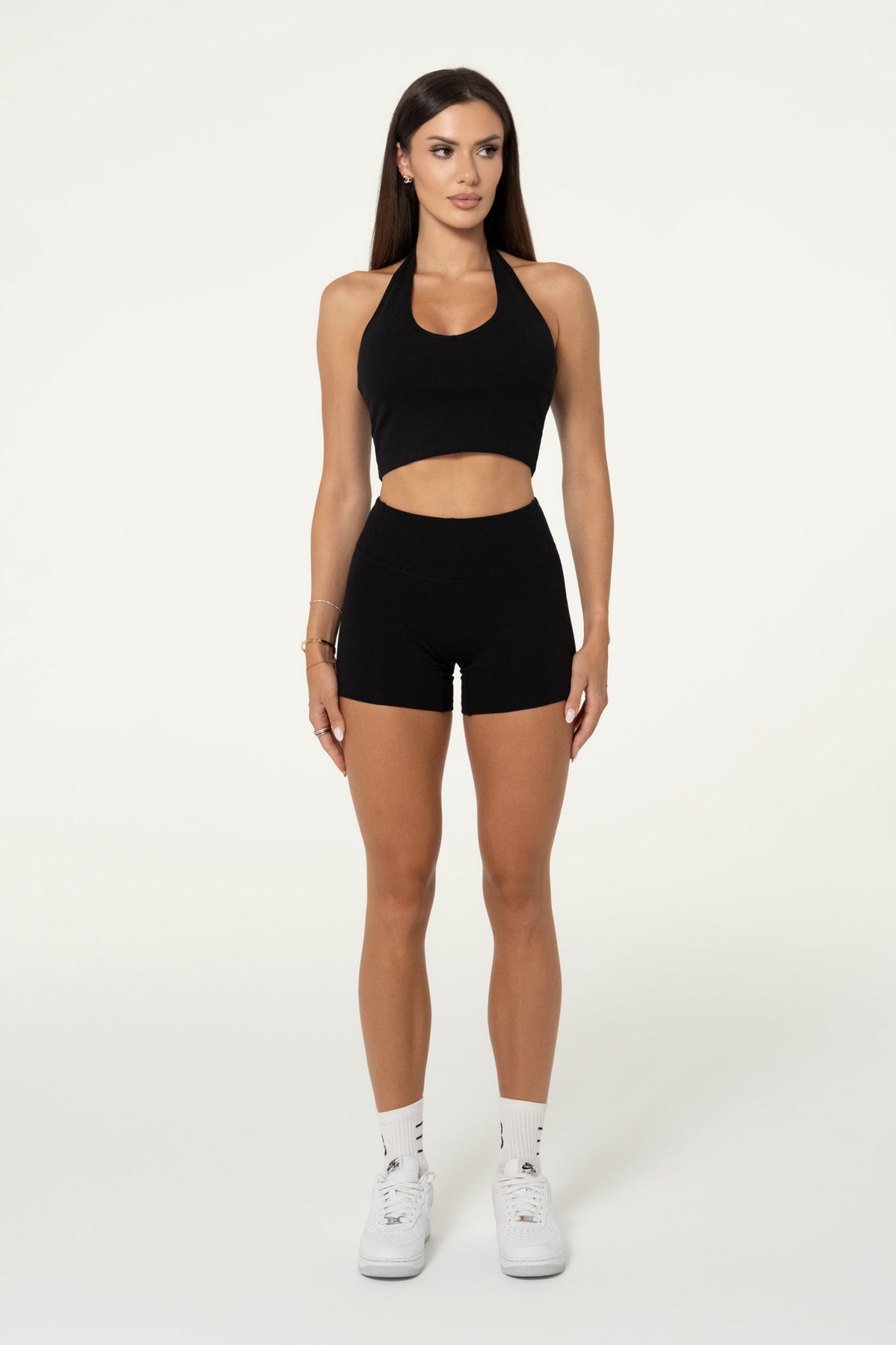 Black organic cotton shorts worn with a matching top, full-length view.