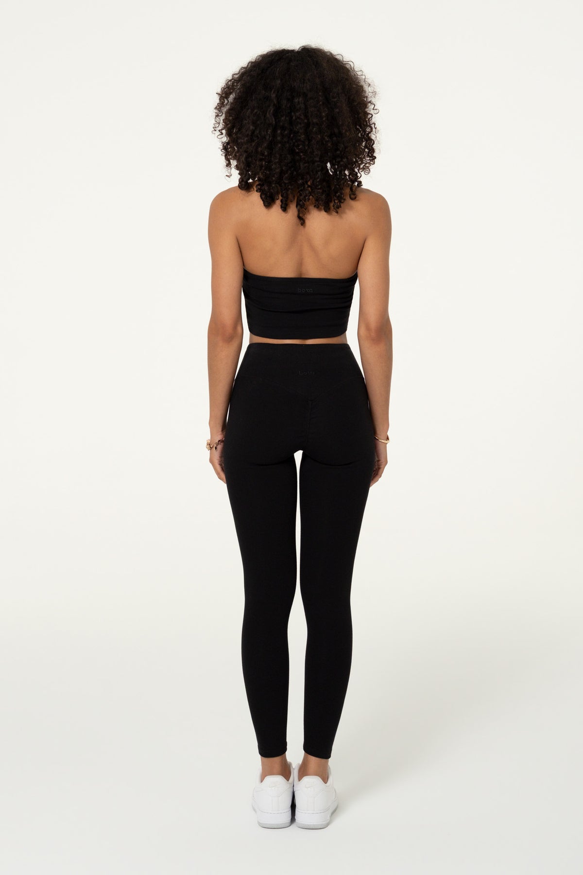 Back view of a black organic cotton halter top.