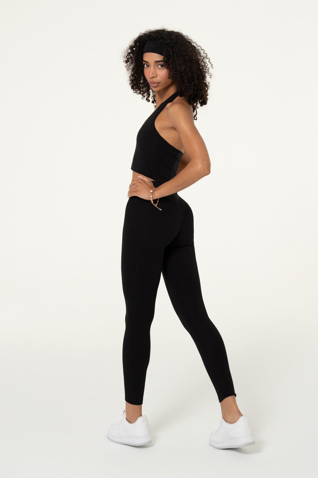 Black organic cotton full-length leggings worn with a matching top.