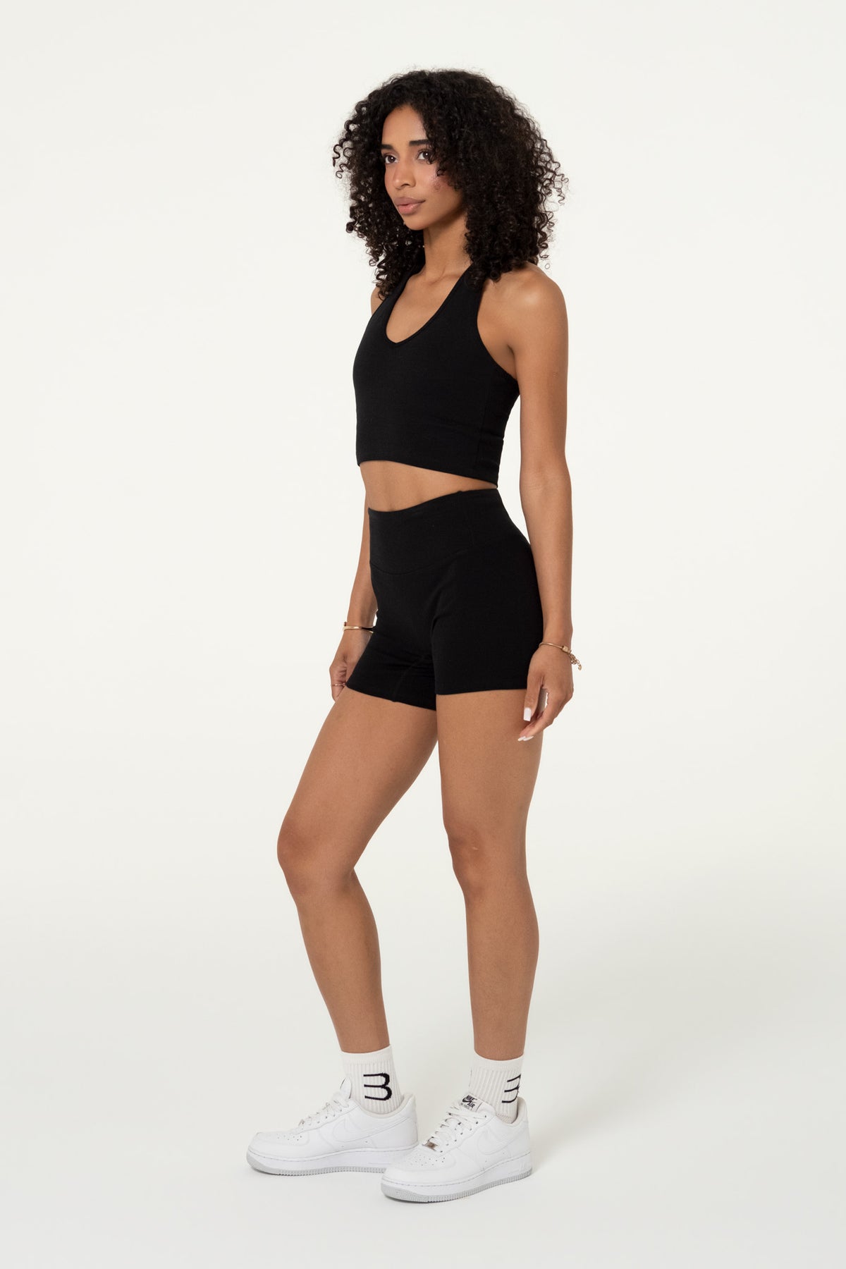 Side view of black organic cotton high-waisted shorts.