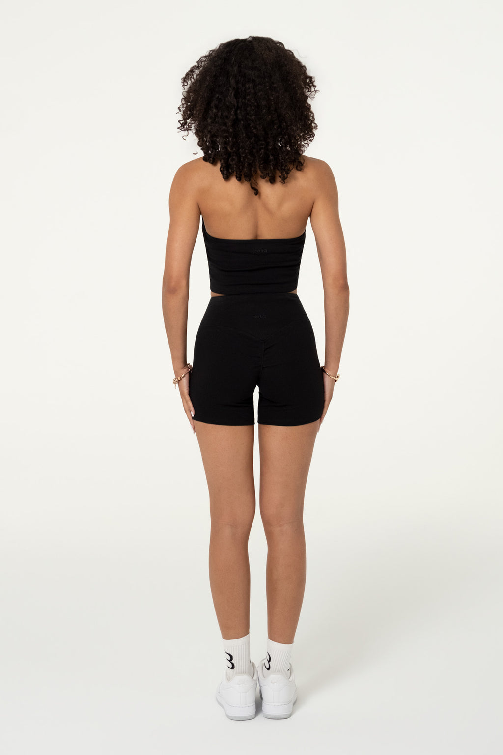 Back view of black organic cotton high-waisted shorts.