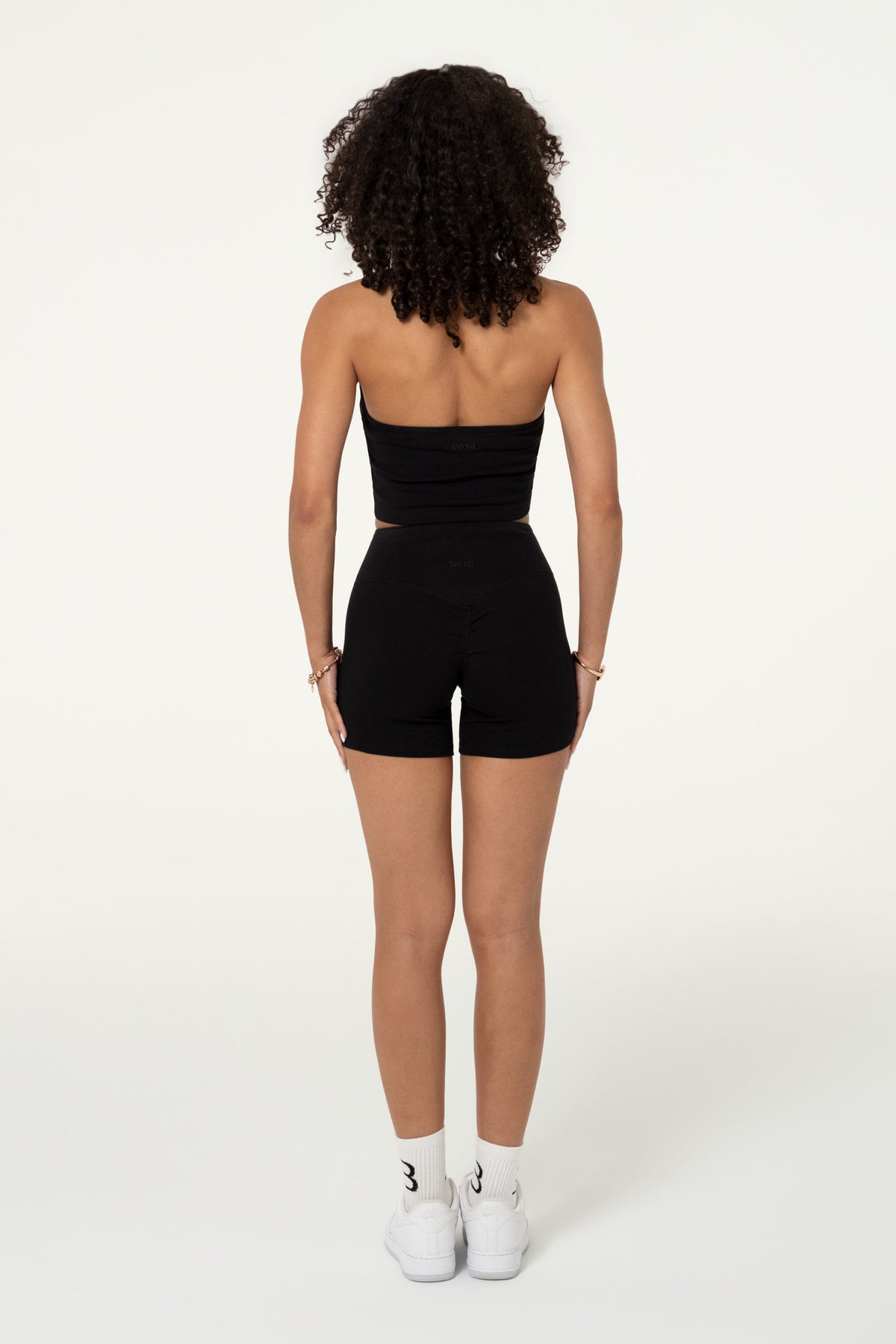 Back view of black organic cotton high-waisted shorts.