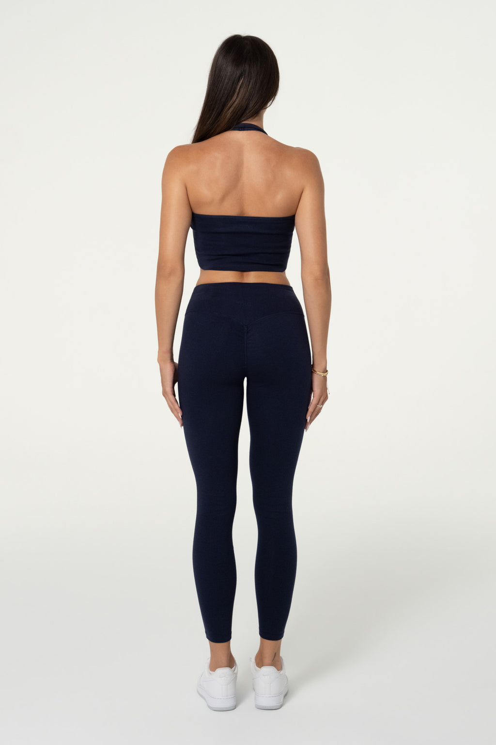 Back view of navy organic cotton high-waisted leggings and halter top.