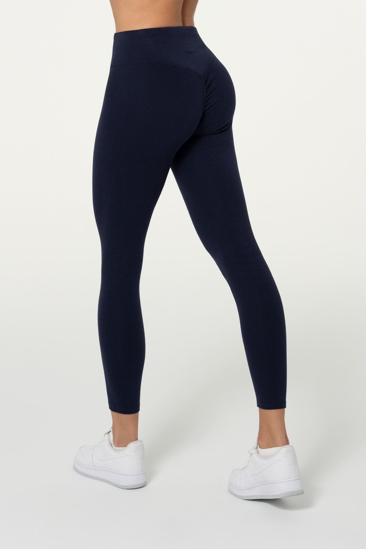 Front view of navy organic cotton 7/8 leggings and halter top set.