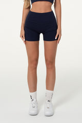 Front view of navy organic cotton high-waisted shorts.