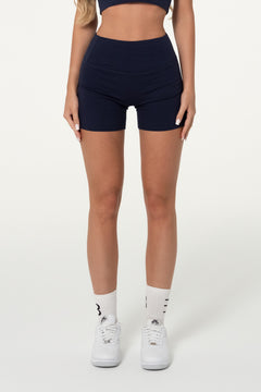 Front view of navy organic cotton high-waisted shorts.