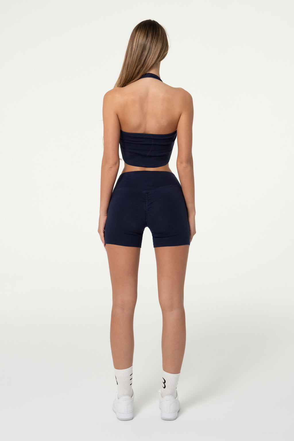 Navy organic cotton halter top showing the cropped, fitted silhouette.