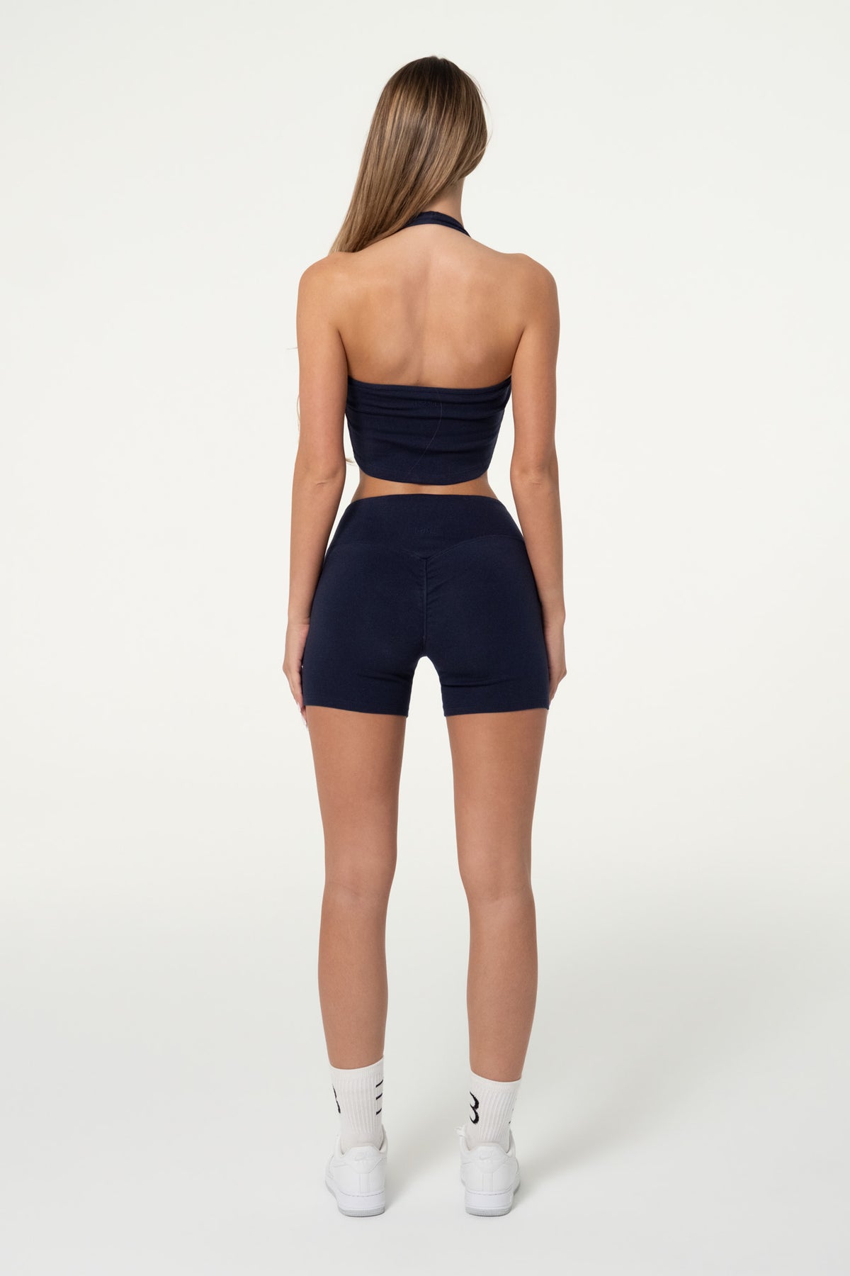 Navy organic cotton halter top showing the cropped, fitted silhouette.