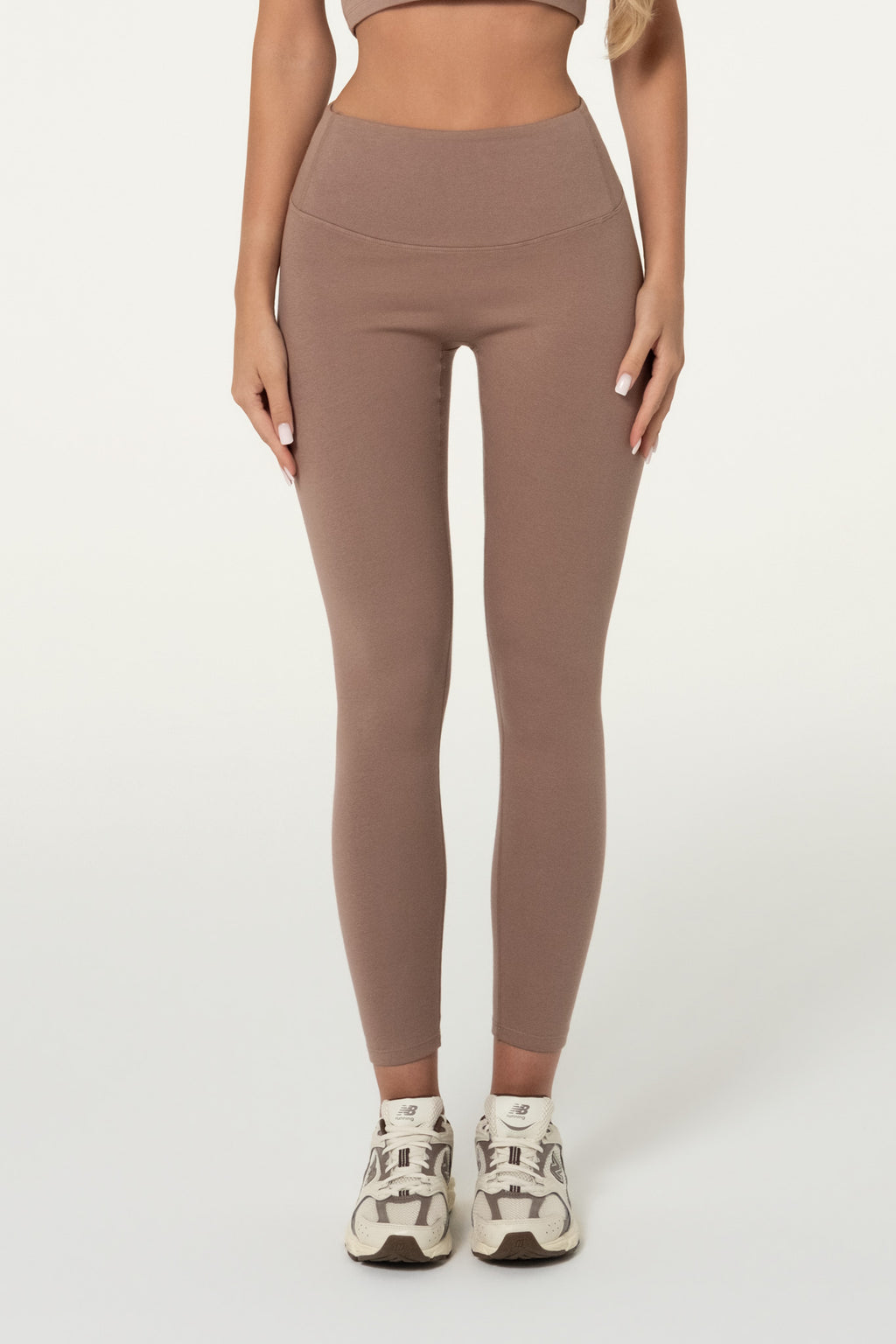 Woman wearing truffle brown organic cotton high-waisted leggings