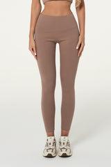 Woman wearing truffle brown organic cotton high-waisted leggings
