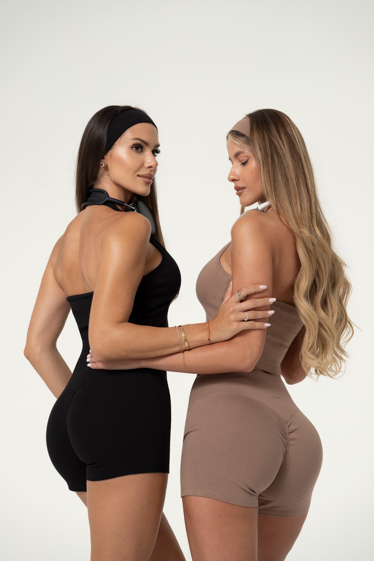 Two women wearing truffle organic cotton activewear shorts.