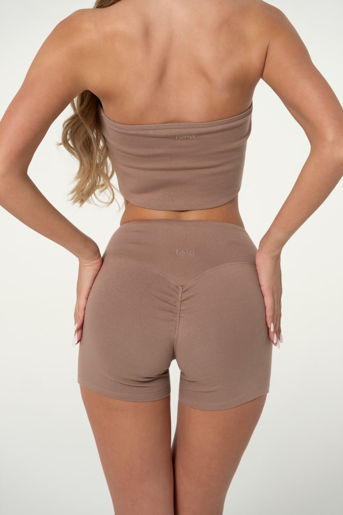 Back view of truffle organic cotton scrunch shorts with wide waistband.