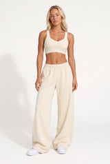 Buttercream organic cotton sports bra and matching sweatpants, full-length view.