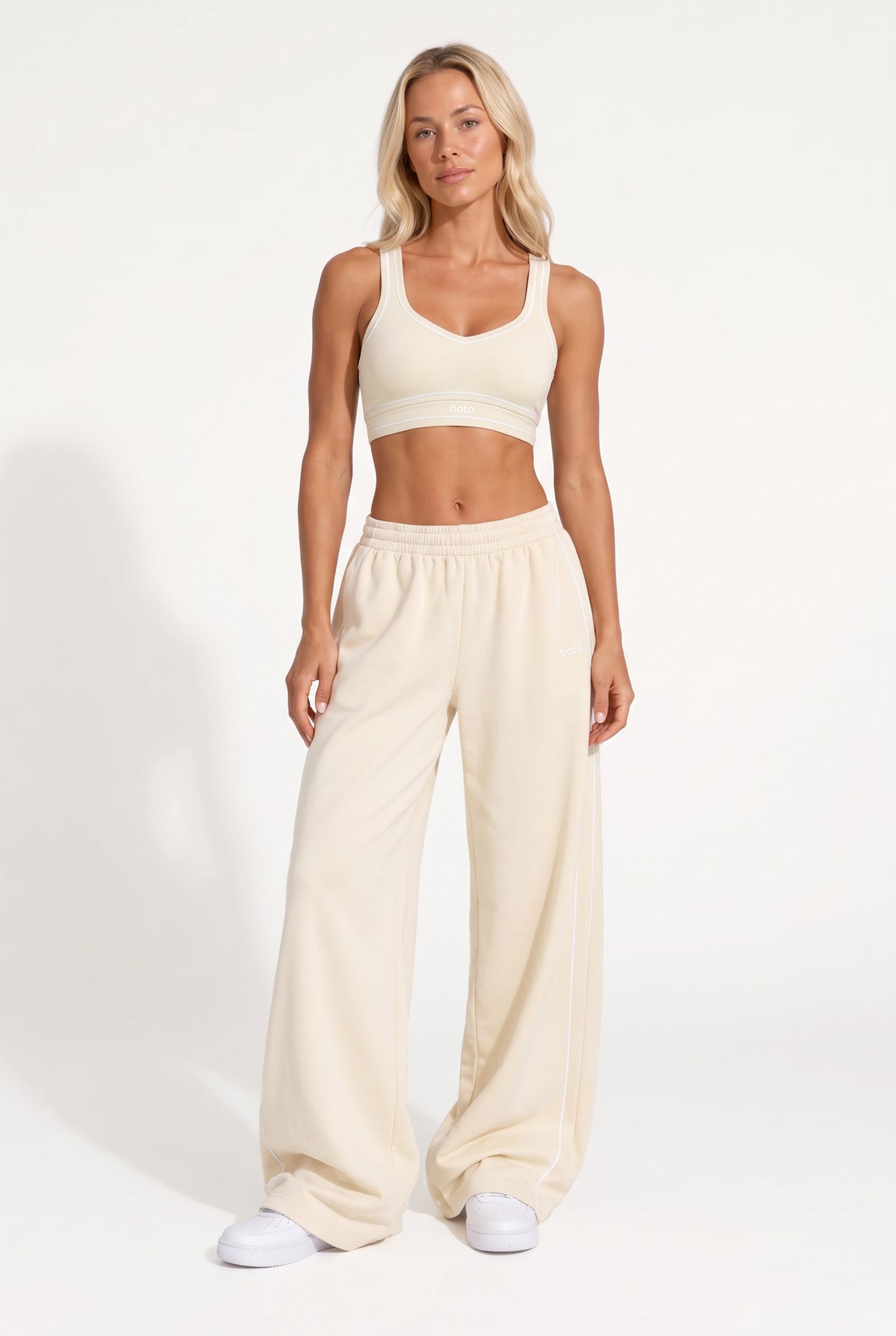 Buttercream organic cotton sports bra and matching sweatpants, full-length view.