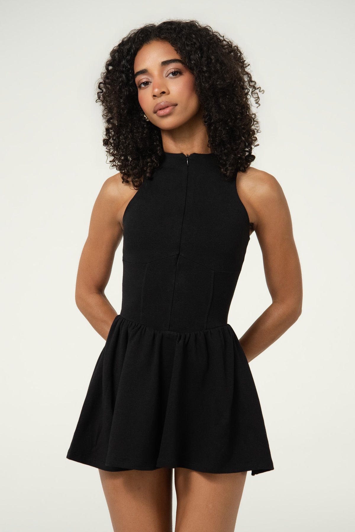 Close-up of a black organic cotton tennis dress with a fitted bodice.