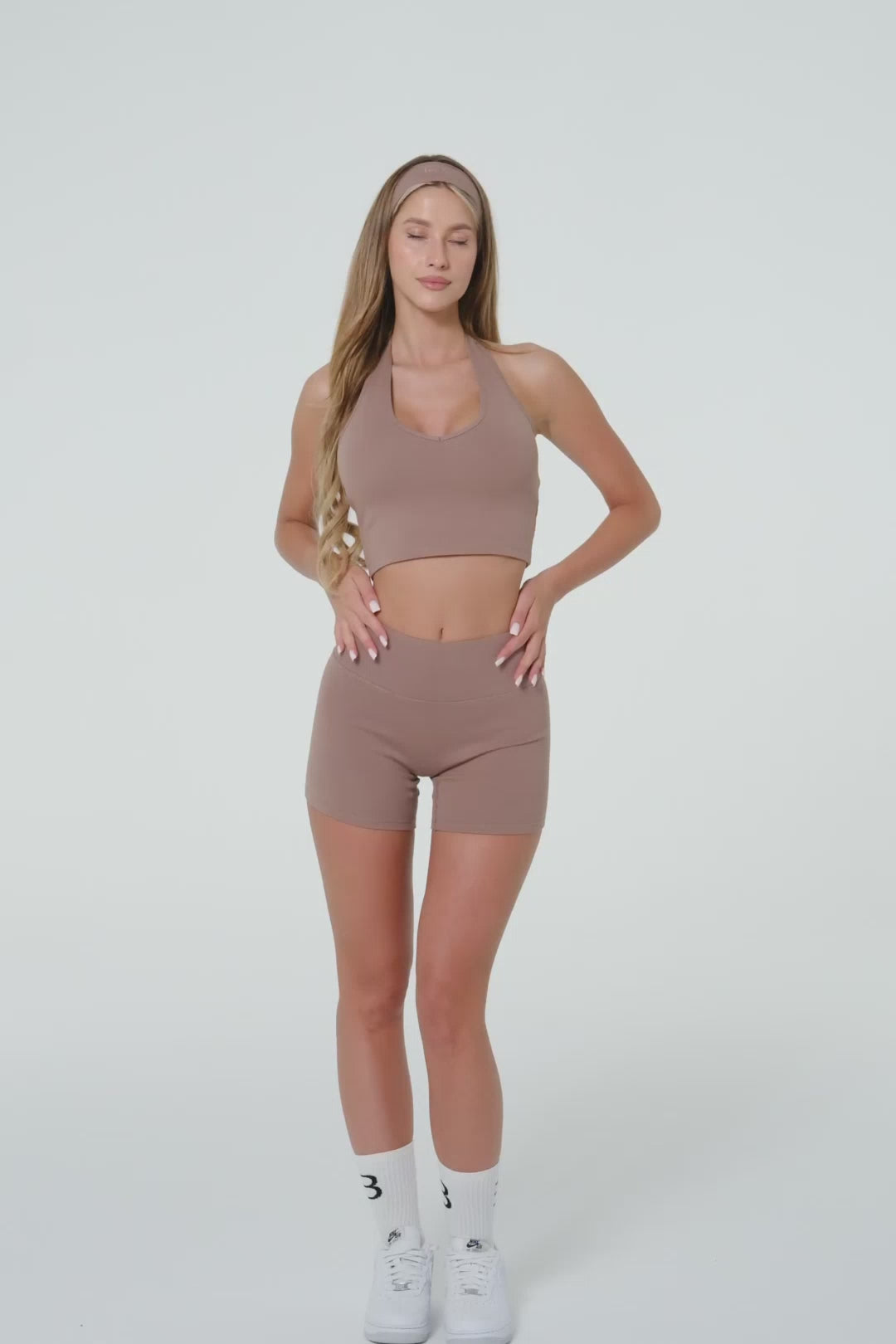 Model wearing truffle organic cotton high-waisted scrunch shorts.